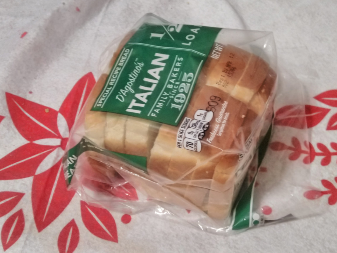 A half-loaf of bread, rolled up in its own wrapper